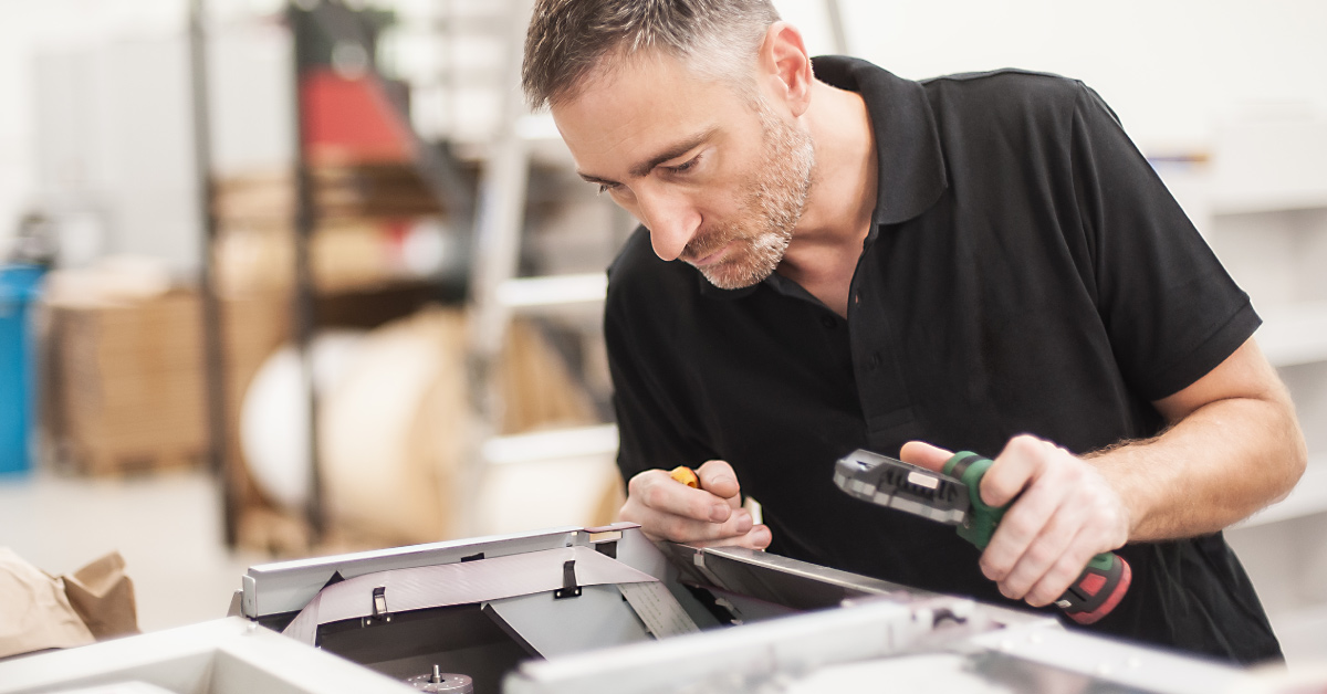 employee maintaining printer
