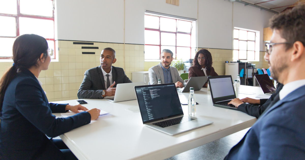 An IT professional explains their cybersecurity expertise to a group of school administrators.