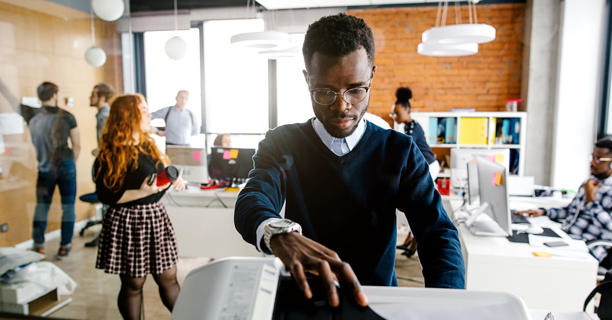 Employee printing on office printer.