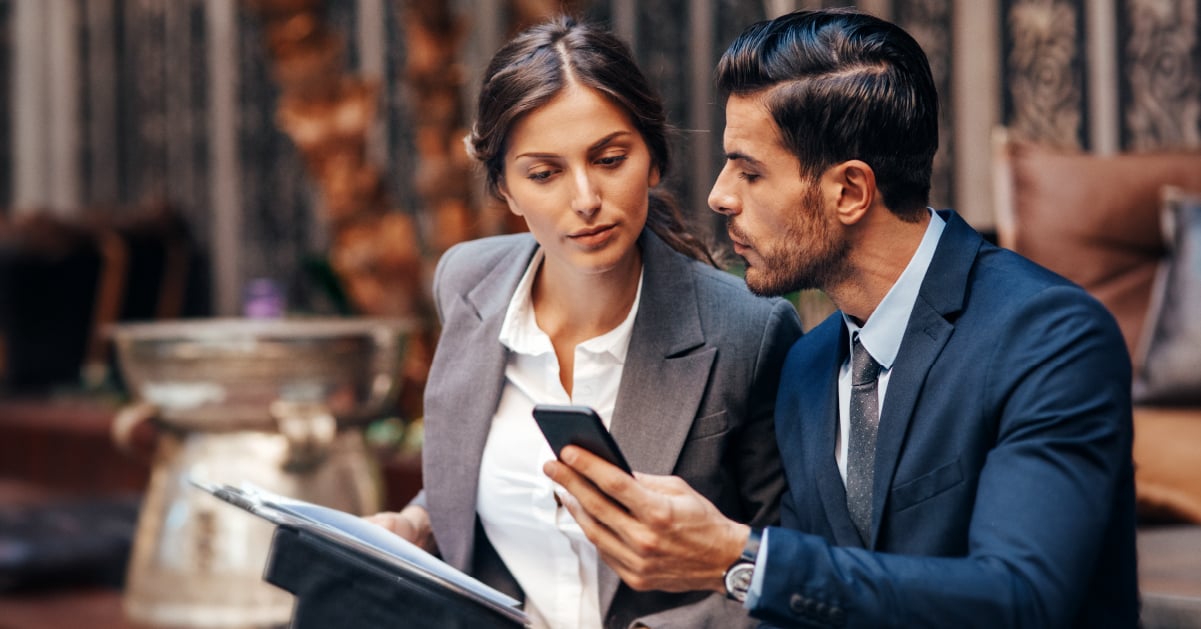 Two coworkers compare which print software makes sense for their organization and its printing requirements.