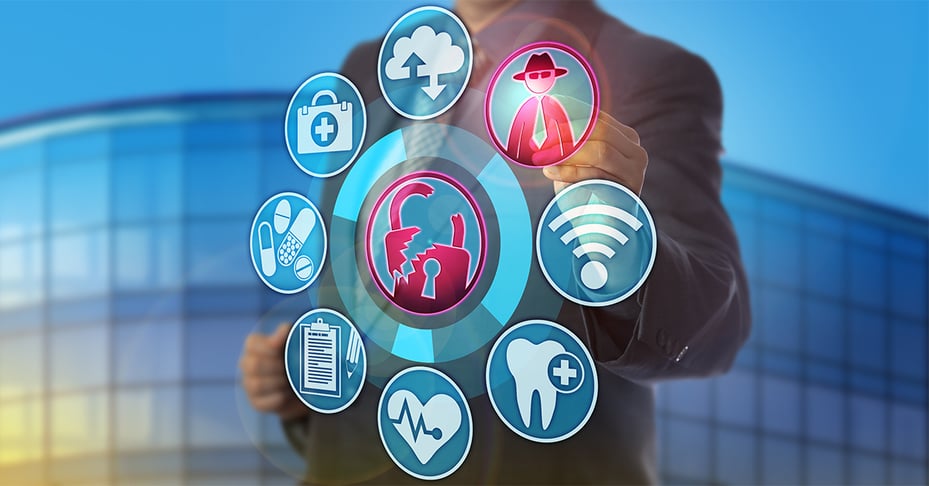 Healthcare executive looking at healthcare cybersecurity icons.