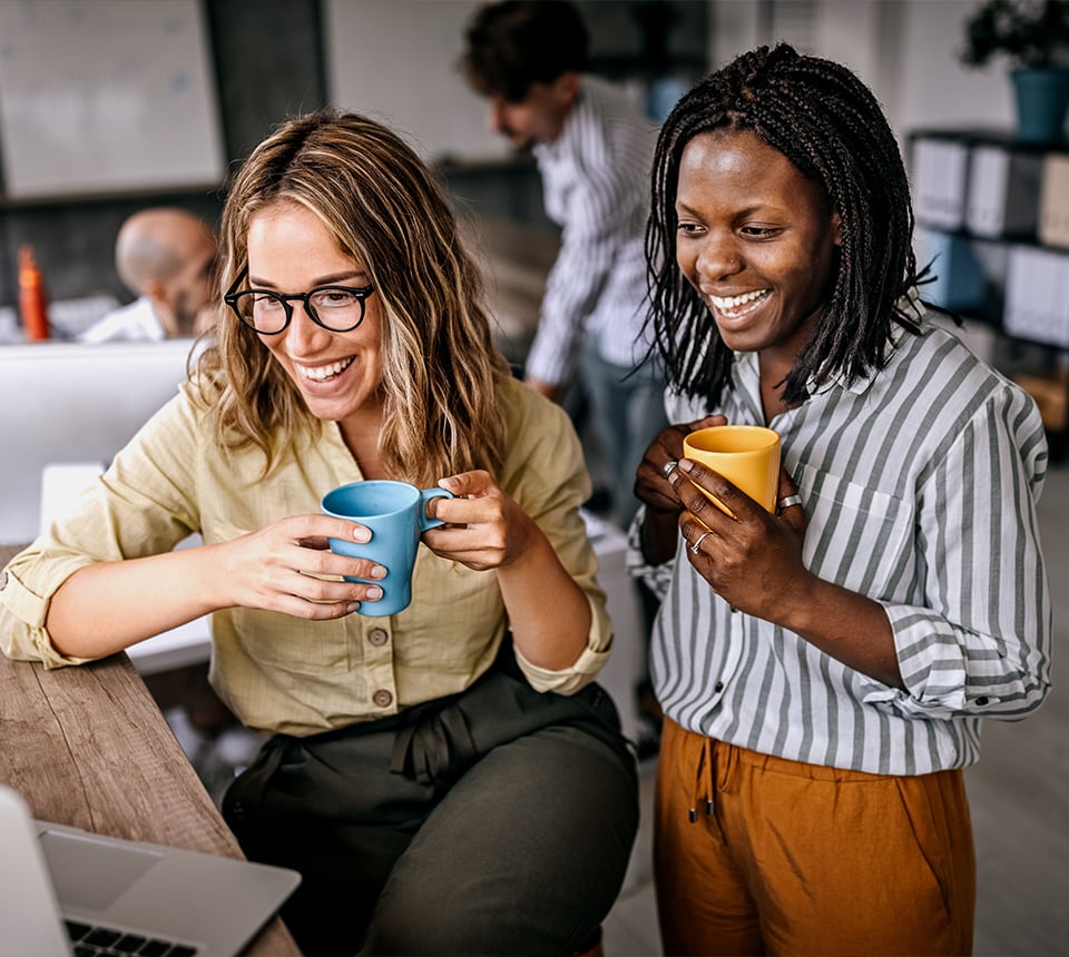 Two smiling workers on break