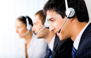 IT support team talking on phone headsets. 