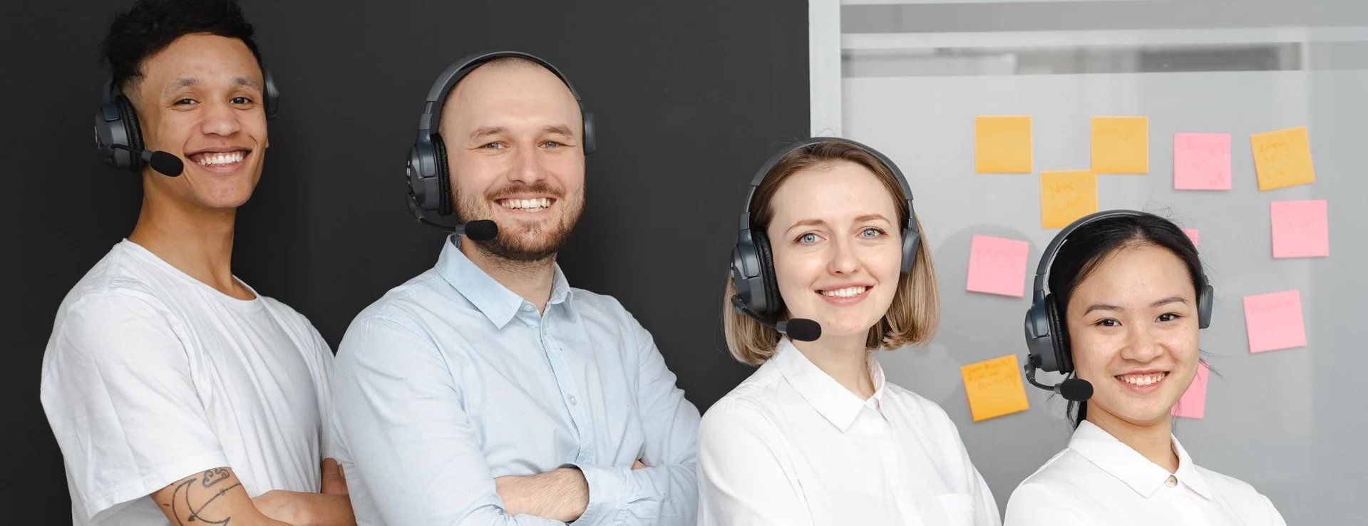 4 smiling employees lined up