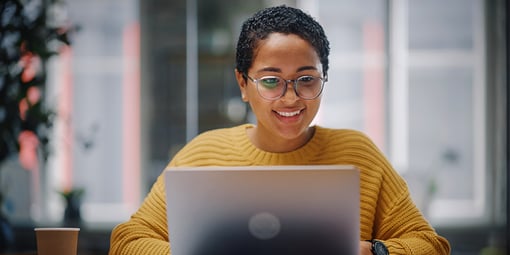 Woman smiling with a laptop