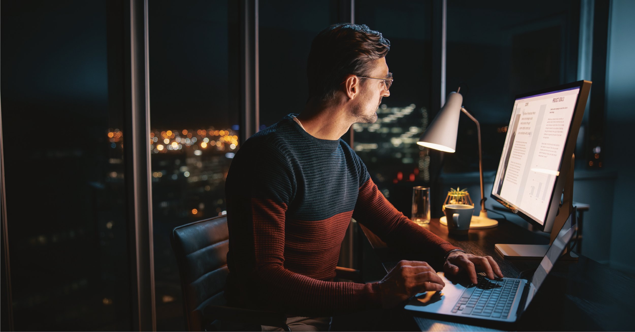 An IT employee performing a cloud migration after hours to avoid a disruption to critical workflows.