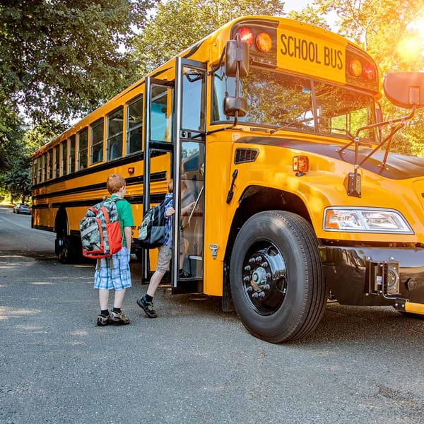 Kids getting on a school bus