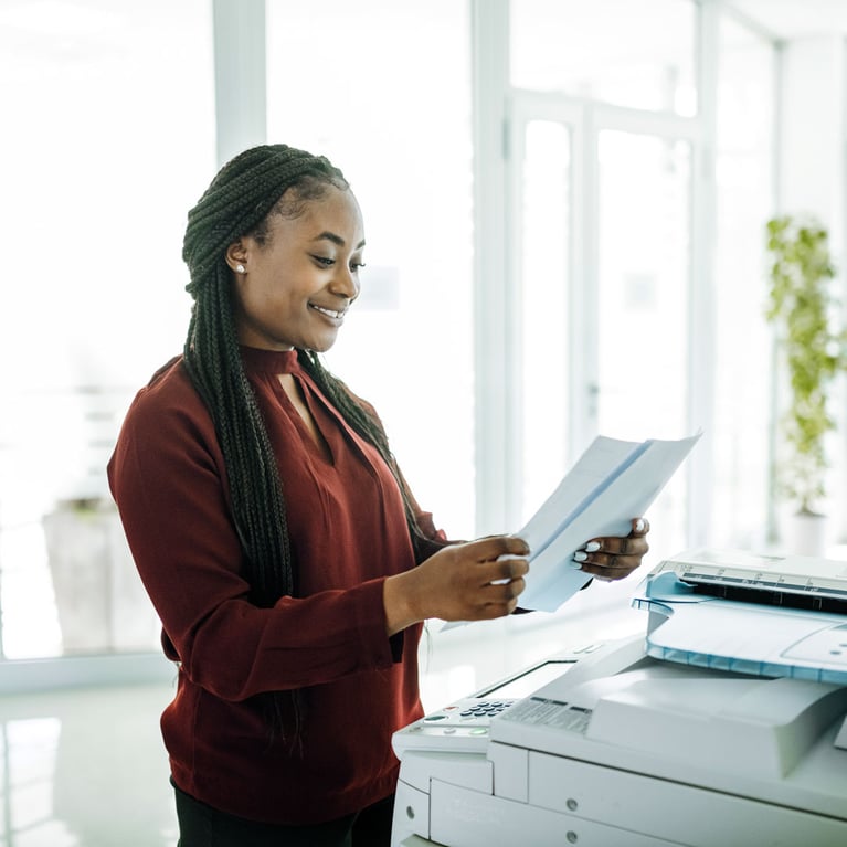 Smiling worker using printer