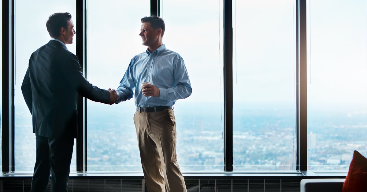 Print provider meeting with law firm owner shaking hands. 