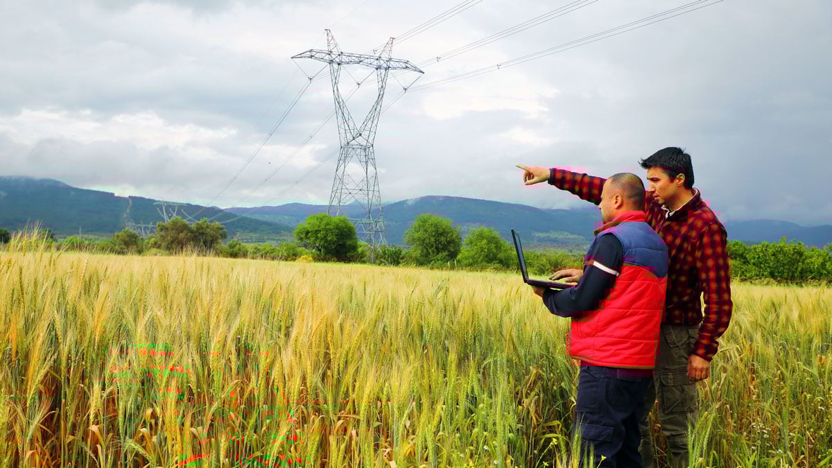 Two workers assess internet connectivity in rural America.