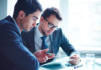 Two businessmen having a discussion about paperwork